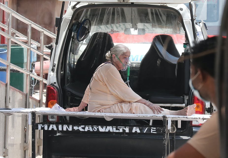 A patient in New Delhi is moved to designated COVID-19 hospital area. EPA