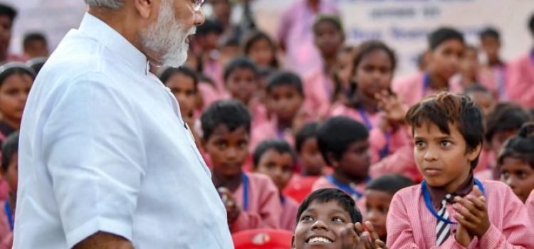 Varanasi: Prime Minister Narendra Modi  interacts with school children as part of his 68th birthday celebrations, at a school at Narur, Varanasi, Monday, Sep 17, 2018. (PIB Photo via PTI)  (PTI9_17_2018_000197B)
